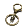 Macro detail of bronze lobster clasp keychain with rotating swivel and metal split ring - Antique Bronze