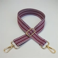 Detail of adjustable crimson and white herringbone strap with gold metal swivel clasps - Brown