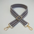 Detail of adjustable geometric woven strap with gold metal hardware on white background - Gray / Gold Buckle