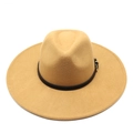 Detail of camel wool fedora hat with a black leather band and gold metal buckle - Camel