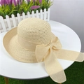 Light beige straw sun hat with large bow detail on a white table for women - Adjustable M (56-58cm) / Beige
