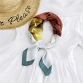 Elegant rust red and yellow printed silk scarf styled as a necktie on a white shirt - Teacup Green