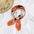 Elegant silk scarf in orange with blue floral pattern styled on a white dress - Mirror Cat Orange Red