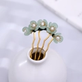 Elegant gold U-shaped hair pin with green flowers and pearls in a ceramic vase - Green