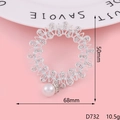 Macro shot of a silver floral brooch with small rhinestones and a white pearl drop detail - Silver Rhinestone Circle Pearl