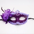 Detail of purple lily masquerade mask with fabric flower feathers and heart gemstone - Purple