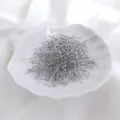 Flat head pins in silver finish for jewelry making displayed on a white shell dish - 0.5x26mm (100 Pcs) / White Gold