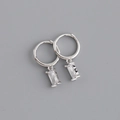 Detail of silver hoop earrings with rectangular clear zircon pendants on grey background - White Gold, White Zirconia