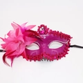 Close-up of rose red masquerade mask featuring side feathers and pink gemstone inlay - Rose Red