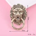 Detailed macro view of vintage lion head alloy charm with antique gold relief and engraved ring - Antique Bronze Lion Head