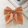 Elegant peach pink oversized bow hair clip with ribbons and matte fabric texture - Orange