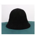Detailed view of black knitted chenille bucket hat texture on a green soft surface - M (56-58cm) / Black