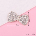 Macro shot of 29mm gold-tone bow charm with clear rhinestones and dimensions - D116 Small Bowknot