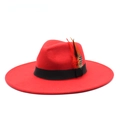 Detail of red wool fedora hat featuring black ribbon band and decorative colored feathers - M (56-59cm) / Red