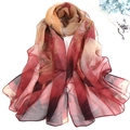 Detail view of red and camel lotus print silk scarf with luxury floral line patterns - Red