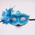 Detail of blue masquerade mask featuring feather flowers and faux sapphire gems - Blue