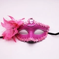 Detail of fuchsia masquerade mask with vibrant feathers, sequins and center gemstone - Pink