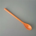 Top view of a bright orange long-handle melamine dessert spoon on a sleek grey background - Orange