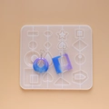 Detailed view of DIY silicone mold with geometric shapes and finished resin earrings - Earring Pendant Water Drop Hollow Mold