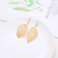Elegant gold leaf earrings with intricate hollow vein details on a minimalist ceramic plate - Gold Textured Leaf Earrings