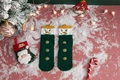 Detail of green knit Christmas socks with snowman design and holiday props - One Size / Dark Green Snowman Gift Style
