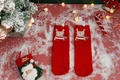 Detail of red knitted Christmas socks with a cute bear pattern in a festive setting - One Size / Red Scarf Bear