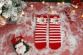 Close-up of red and white striped Christmas socks with 3D cartoon dog ear detail - One Size / Red White Stripe Dog