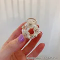 Mini floral hair claw clip with white pearls and rhinestones on hand, 3.2cm height - Hollow Style / Hollow Pearl Claw Clip Small