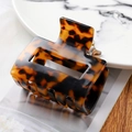 Detailed view of rectangle tortoiseshell acetate hair claw clip on marble background - 7145-5 Tortoiseshell