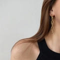 Fashionable gold chain drop earrings worn by a model, featuring polished oval link designs - Long Style / Gold