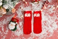 Close-up of red Christmas crew socks with Santa Claus pattern and matching gift bag - One Size / Red Santa Claus