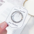 Classic round rhinestone-studded brooch in alloy finish on jewelry display card - Small Round / Silver