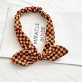 Bandeau élastique en velours avec un nœud au motif à damier orange et violet - Damiers Jaune & Violet