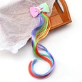 Detail of unicorn hair clip featuring rainbow hair extensions and a pastel ribbon bow - Unicorn - Multicolored
