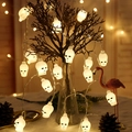 LED skull string lights hanging on branches for Halloween party decoration - White Belt Skull Buckle