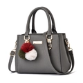 Elegant gray lychee texture tote bag with golden hardware and colorful pompom charm - Dark Gray