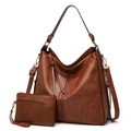 Detailed shot of brown leather tote bag with matching zippered coin purse and strap - Two-Piece Set / Brown