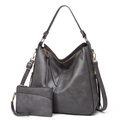 Detail of dark gray faux leather tote set with gold hardware and tassel accents - Two-Piece Set / Gray