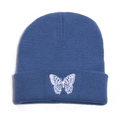 Detail of blue knitted beanie with white butterfly embroidery and premium rib texture - M (56-58cm) / Blue