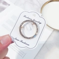 Minimalist gold-tone round brooch with pavé sparkling crystals on a fashion display card - Small Round / Gold