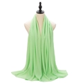 Solid mint green pearl chiffon hijab scarf wrap for women shown on a mannequin - Grass Green