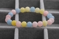 Macro shot of macaron-colored pink yellow and blue beaded bracelets in a velvet box - 8mm