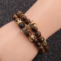 Brown tiger eye stone beaded bracelet set with crown charms on a model wrist - Yellow Tiger Eye Crown Set