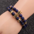 Deep blue beaded bracelet set with gold crown charms on a black textured background - Lapis Lazuli Crown Set