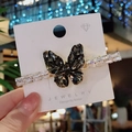 Elegant gold butterfly hair clip with deep gray and white zircons on display card - Gray