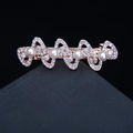 Golden bow-shaped hair clip with sparkling rhinestones and white pearls on dark background - 14# Four Bowknots