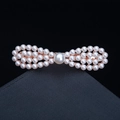 Bow-shaped pearl hair clip with rose gold finish and white pearls on a dark base - 25# Pearl Grass