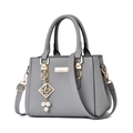 Elegant grey pebbled leather handbag with gold hardware and pearl charm detail - Light Gray With Pearl Pendant
