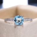 Macro shot of cushion cut light blue zircon gemstone set in a pavé silver ring band - Size 6 / Aqua