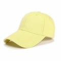 Detail of light yellow cotton baseball cap with six-panel structure and curved brim - Yellow